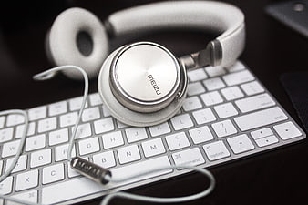 White Meizu Headphones on Silver Keyboard