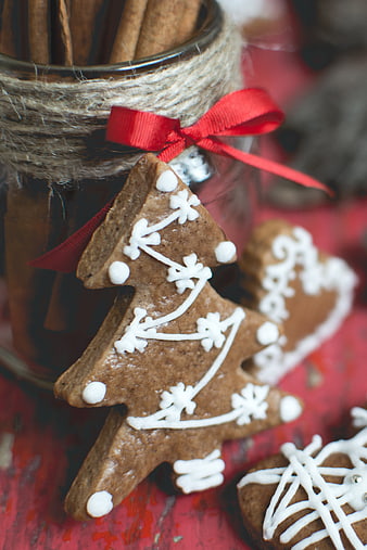Close-up of gingerbread Christmas tree cookie with white icing
