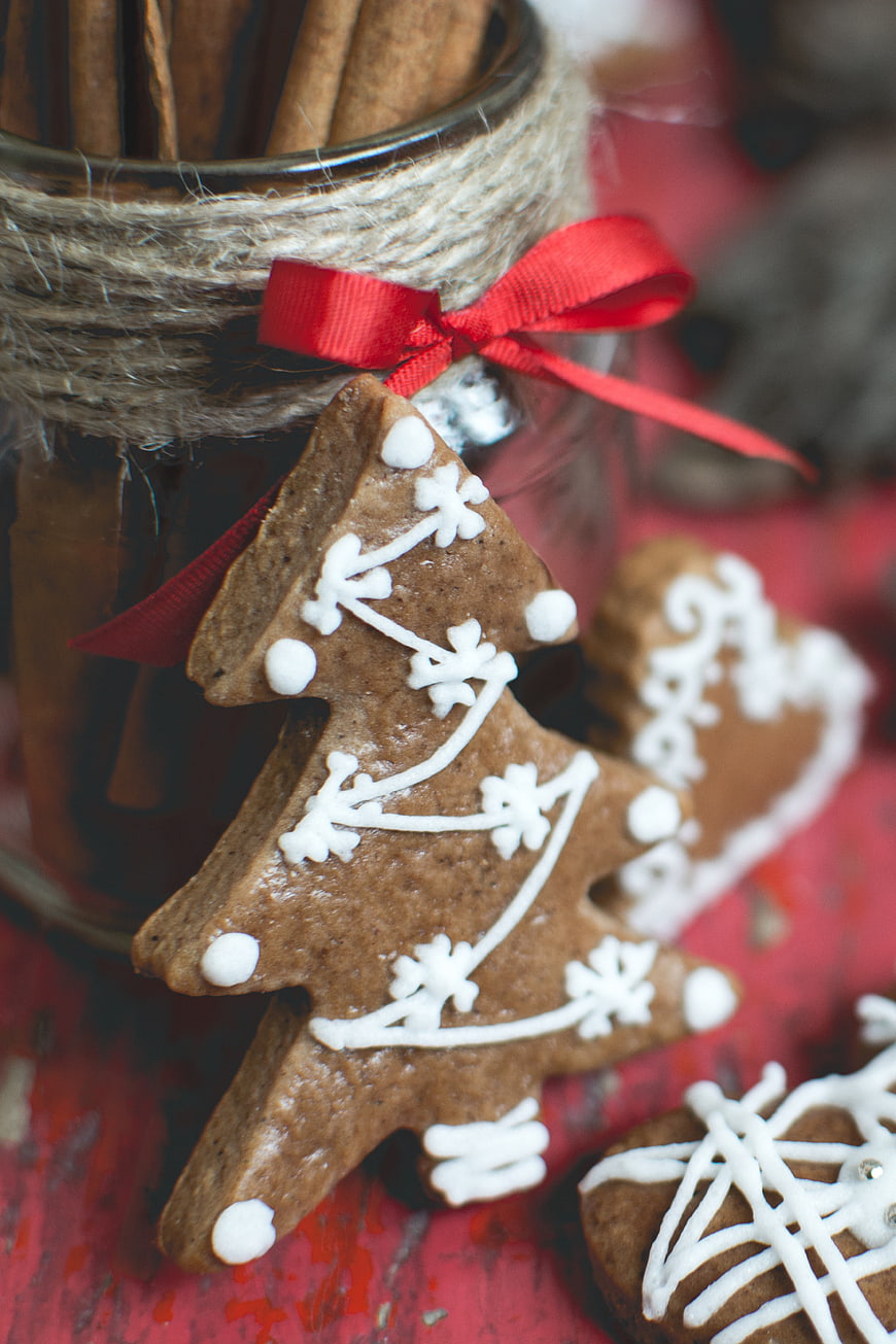 Close-up of gingerbread Christmas tree cookie with white icing