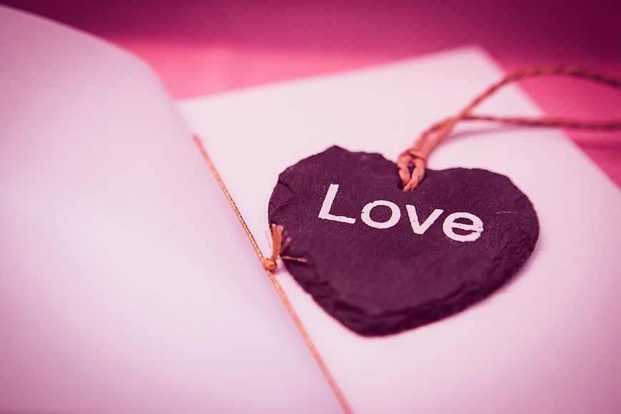 Heart-shaped slate tag with Love text on open book