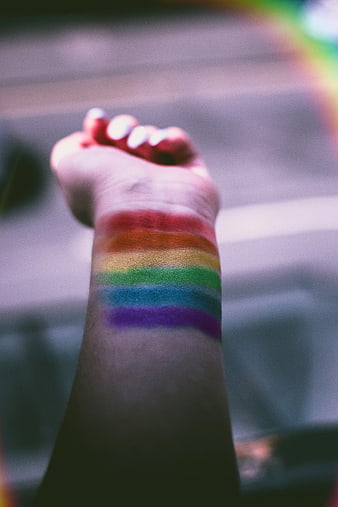 Raised Fist with Rainbow Pride Flag Painted on Wrist