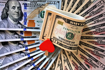 Stack of US Dollar Bills with Red Heart Clip