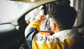 Man in Yellow Jacket Driving Car Interior