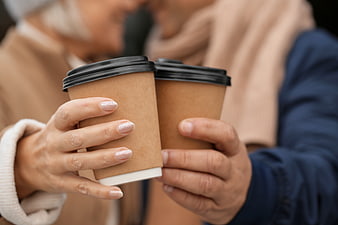 Couple Holding Takeaway Coffee Cups Close Up
