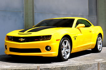 Yellow Chevrolet Camaro SS with Black Racing Stripes Parked Outdoors
