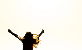 Silhouette of Woman with Arms Raised in Joy