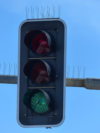 Green Traffic Light Signal Against Blue Sky