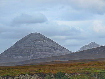 Scenic mountain landscape with rocky peaks and heather moorland