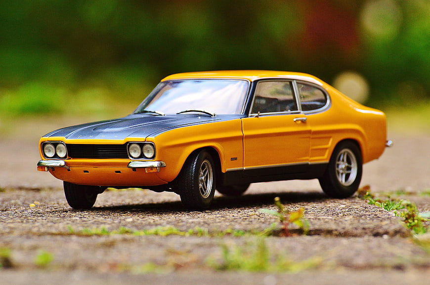 Yellow and Black Classic Model Car on Gravel