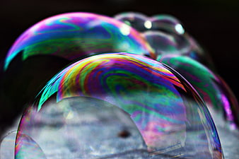 Close-up of iridescent soap bubbles with vibrant rainbow colors