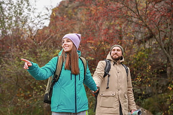 Happy young couple hiking together in autumn nature