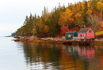 Colorful Boathouses on Rocky Autumn Coastline with Reflections