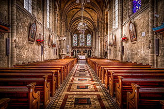 Interior of historic church with wooden pews and stained glass