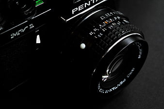 Close-up of vintage black Pentax MV1 camera lens