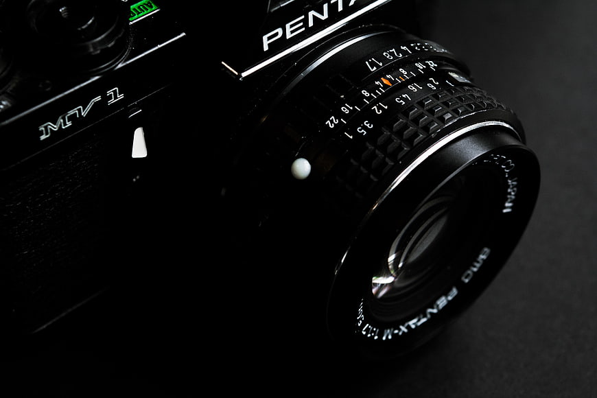 Close-up of vintage black Pentax MV1 camera lens