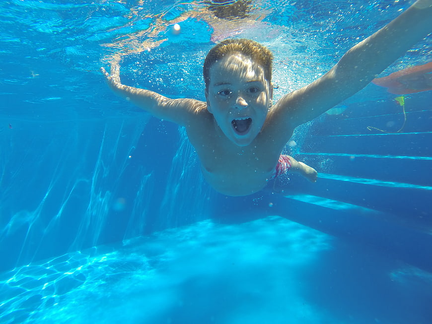 Underwater shot of a boy swimming in a pool