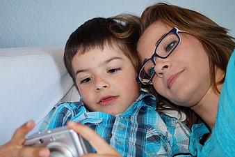 Mother and son looking at digital camera together
