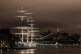 Illuminated Tall Ship in Winter Harbor at Night