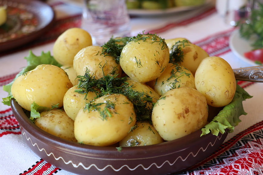 Traditional Ukrainian boiled potatoes with fresh dill in a ceramic bowl