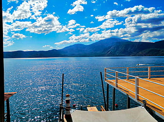 Sunny Lake View with Wooden Dock and Mountains