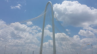 White Cable-Stayed Bridge Arch Against Blue Sky