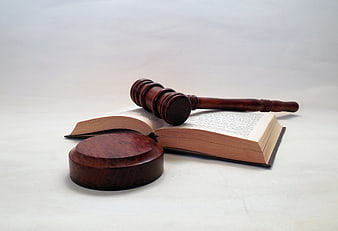 Wooden Gavel And Sound Block On Open Law Book