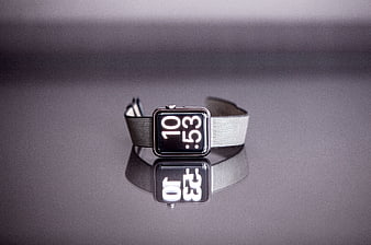 Silver smartwatch with Milanese loop on reflective surface