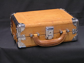Vintage Tan Leather Suitcase With Metal Hardware On Black Background