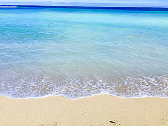 Tropical turquoise ocean waves on sandy beach