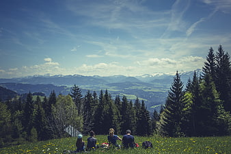 Family Picnic on Mountain Hilltop Overlooking Valley