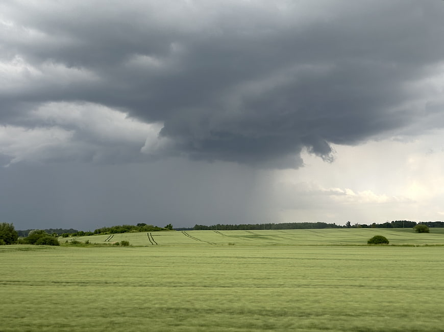 Dramatic Storm Clouds Over Green Rolling Countryside Fields