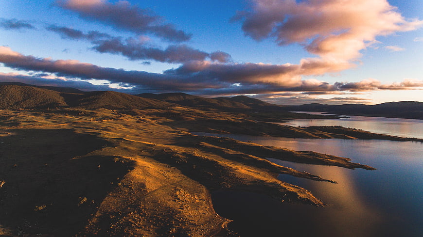 Aerial View of Highland Lake at Sunset with Golden Hills