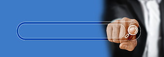 Businessman hand using magnifying glass search icon on blue background