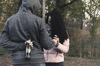 Couple in Conflict with Hidden Alcohol Bottle in Park