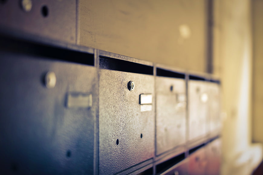 Close-up of vintage metal mailboxes with shallow depth of field