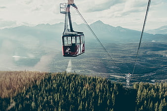 Red Gondola Lift Over Mountain Forest Landscape