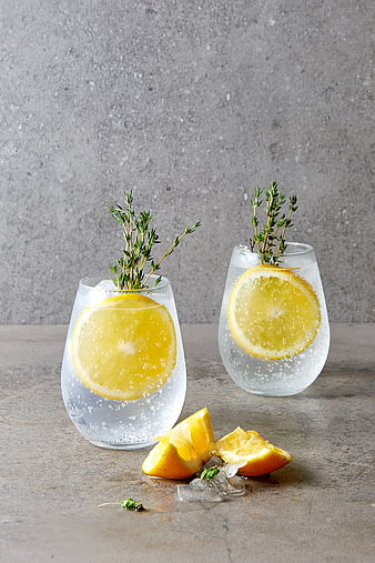 Refreshing Gin and Tonic with Orange and Thyme on Concrete