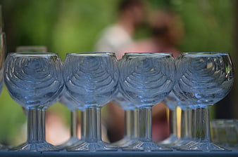 Row of empty blue wine glasses on a table