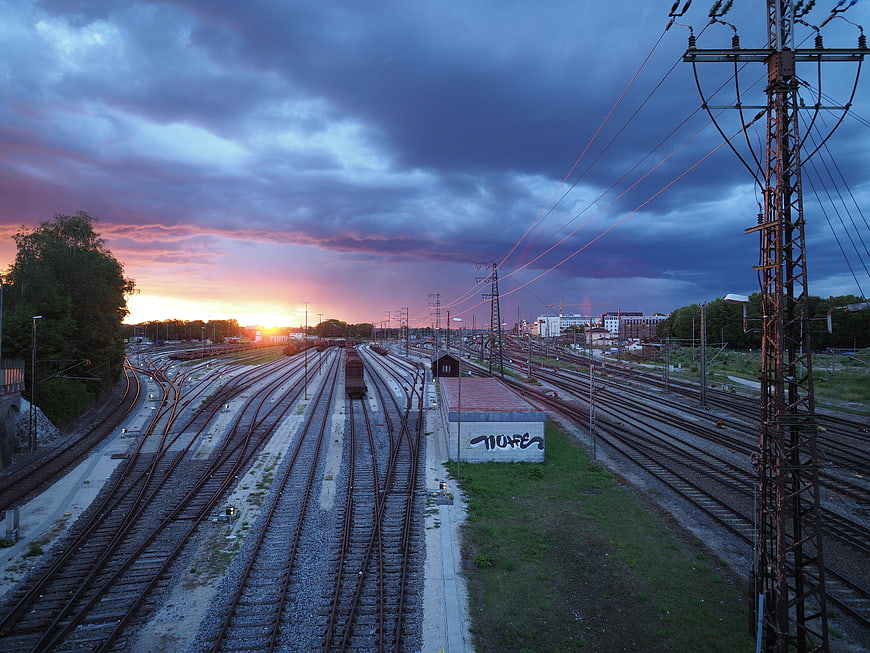Dramatic sunset over railway tracks with freight train