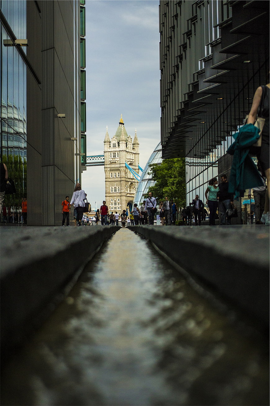 Low angle view of Tower Bridge through urban water channel