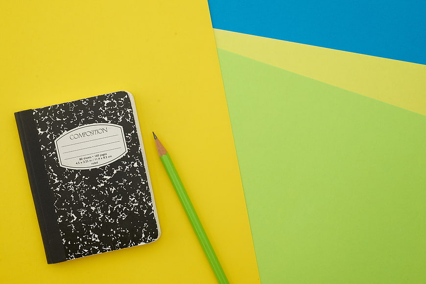 Composition Notebook and Pencil on Colorful Background