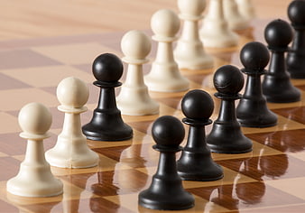 Black and White Chess Pawns on Wooden Board