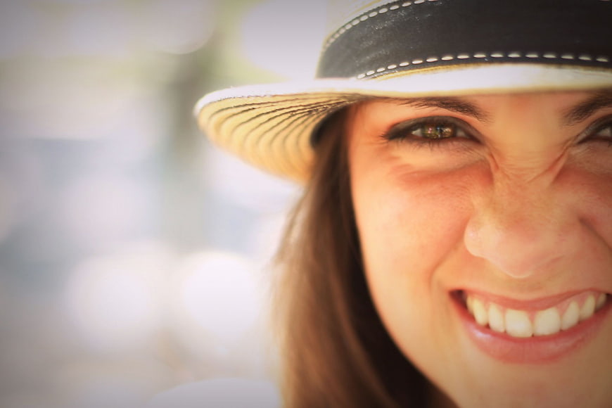Close-up Portrait of Smiling Woman in Straw Hat