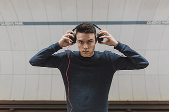 Young Man with Headphones in Subway Station