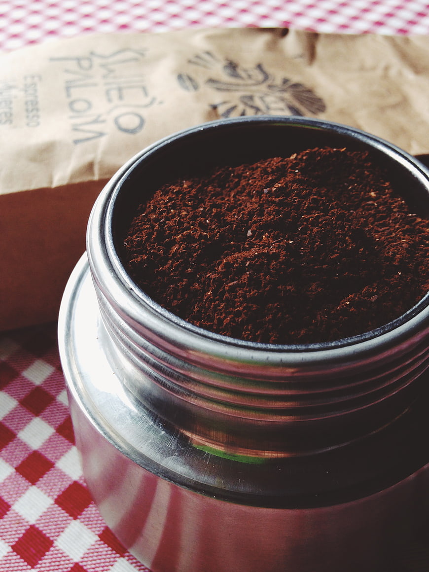 Ground Espresso Coffee in Metal Jar on Checkered Tablecloth