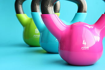 Colorful Kettlebells on Blue Background for Fitness