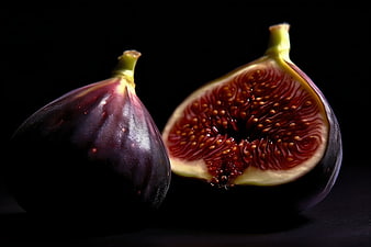 Fresh Purple Fig Cut in Half on Black Background