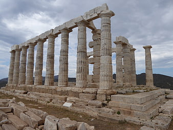 Ancient Greek Temple Ruins with Stone Columns and Cloudy Sky