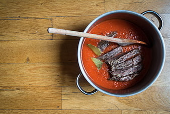 Top view of beef stew in pot with tomato sauce