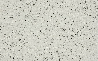 White terrazzo stone texture with black speckles background